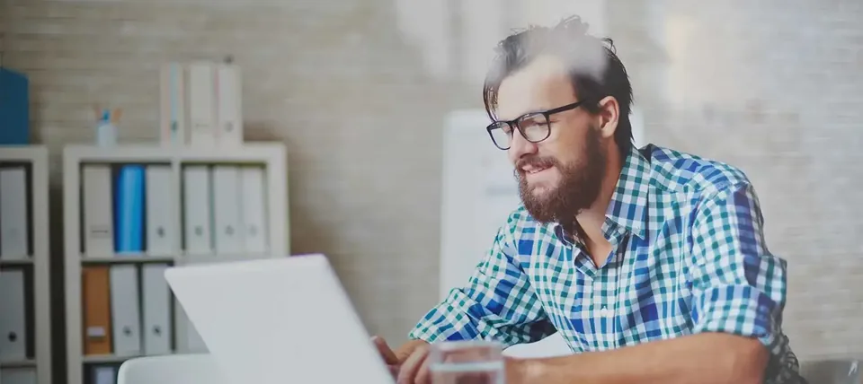 Human editor reviewing AI-generated writing on a laptop