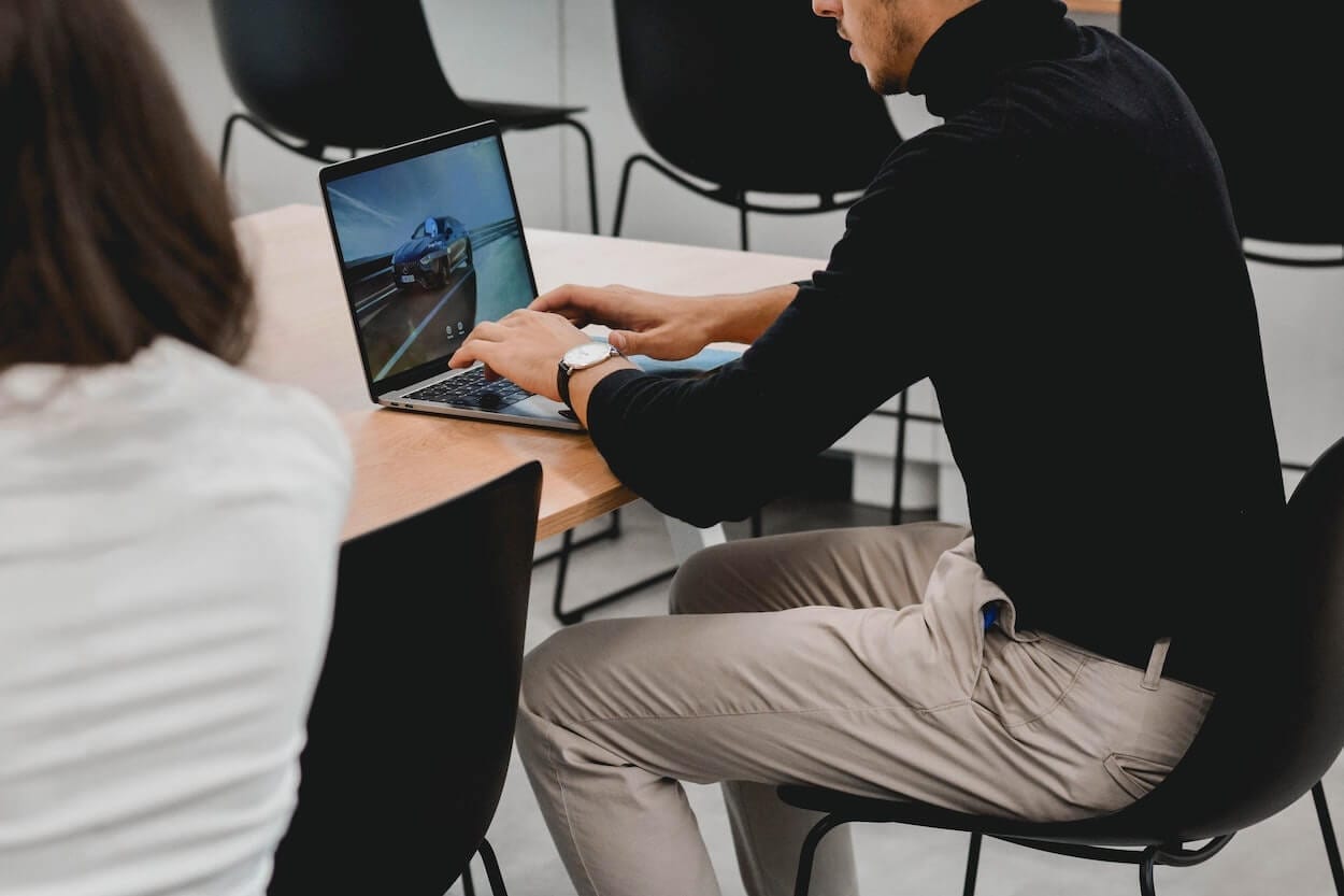 Picture of a man sat at a desk reading an edited document