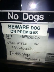 Contradiction is sign that reads "no dogs" and then "beware of dogs on the premises."