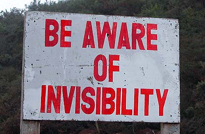 Sign reads: "be aware of invisibility"