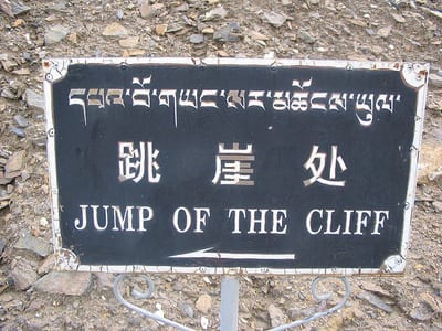 Sign reads: "jump of the cliff"
